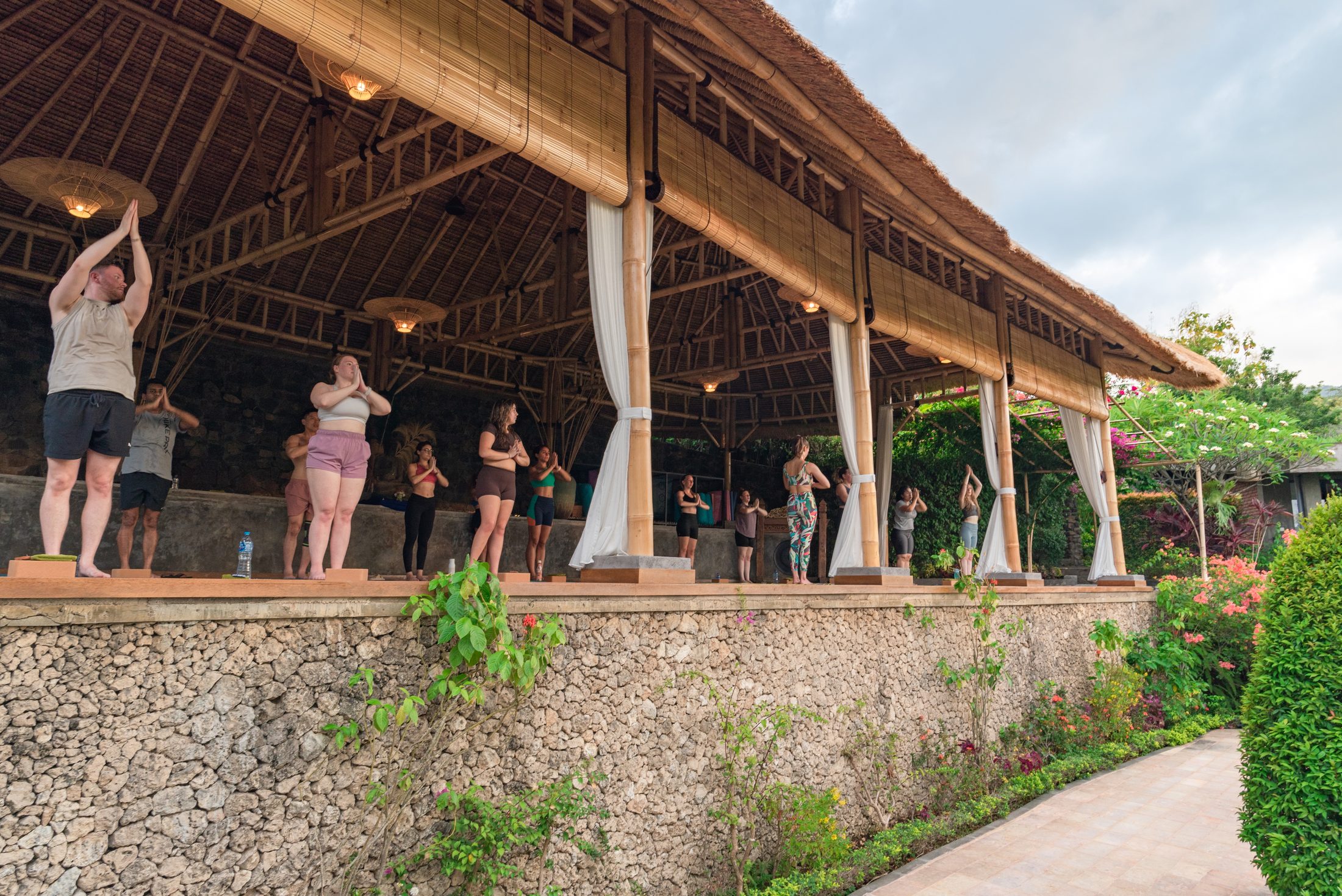 Guest practising yoga in the open-sided Shala at Alamanda