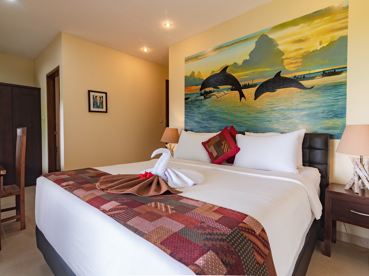 Bedroom of Suite Lumba Lumba at Alamanda with a king bed and dolphin artwork